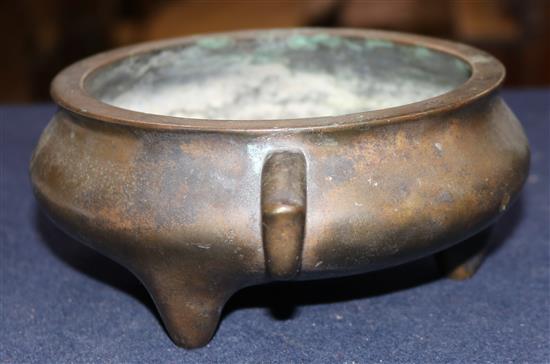 A Chinese brown patinated bronze ding censer, Xuande six character mark, probably 17th/18th century, width 21cm